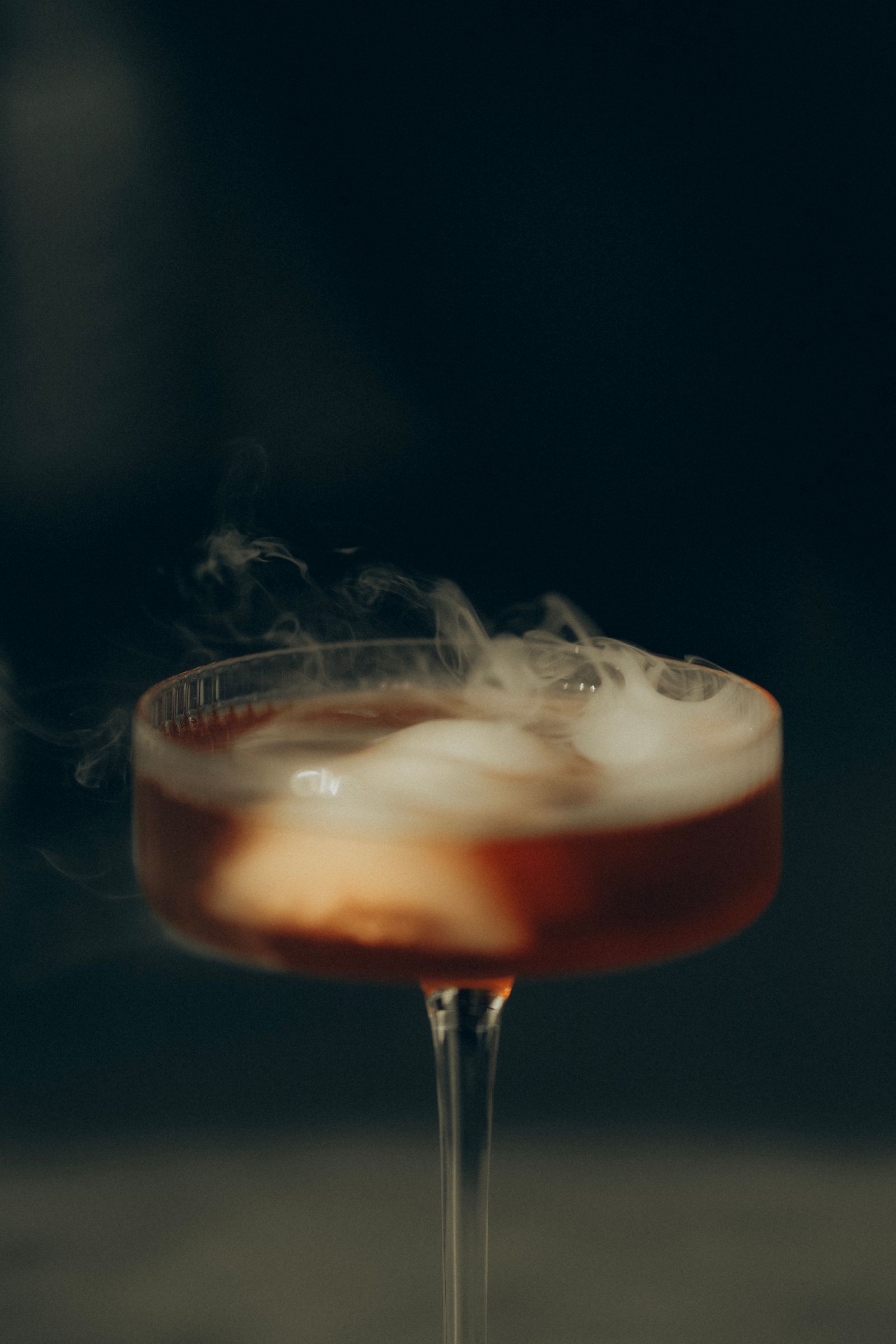 Smoky artisan cocktail in an elegant glass